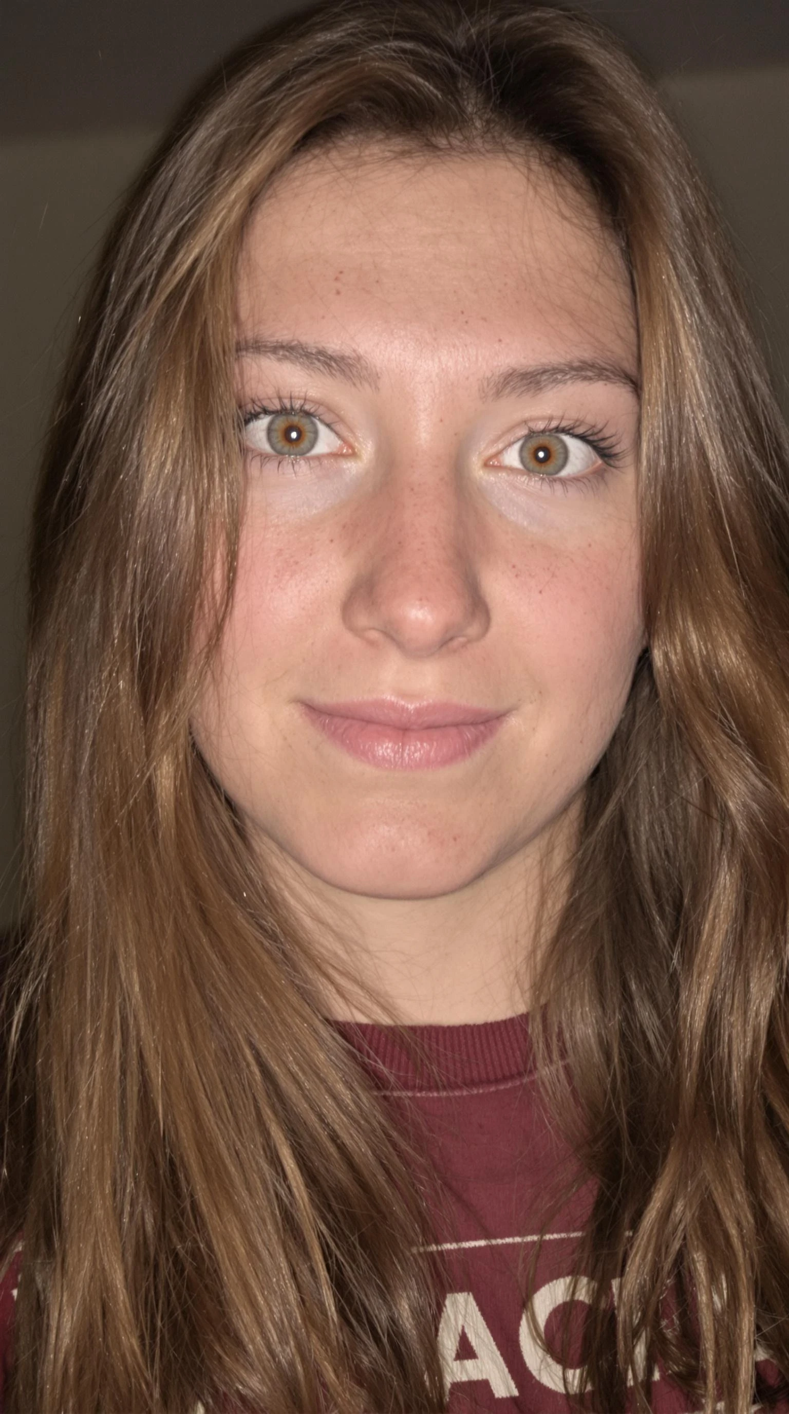 Image of face, 19 year old women, long brown hair, her togue stick out