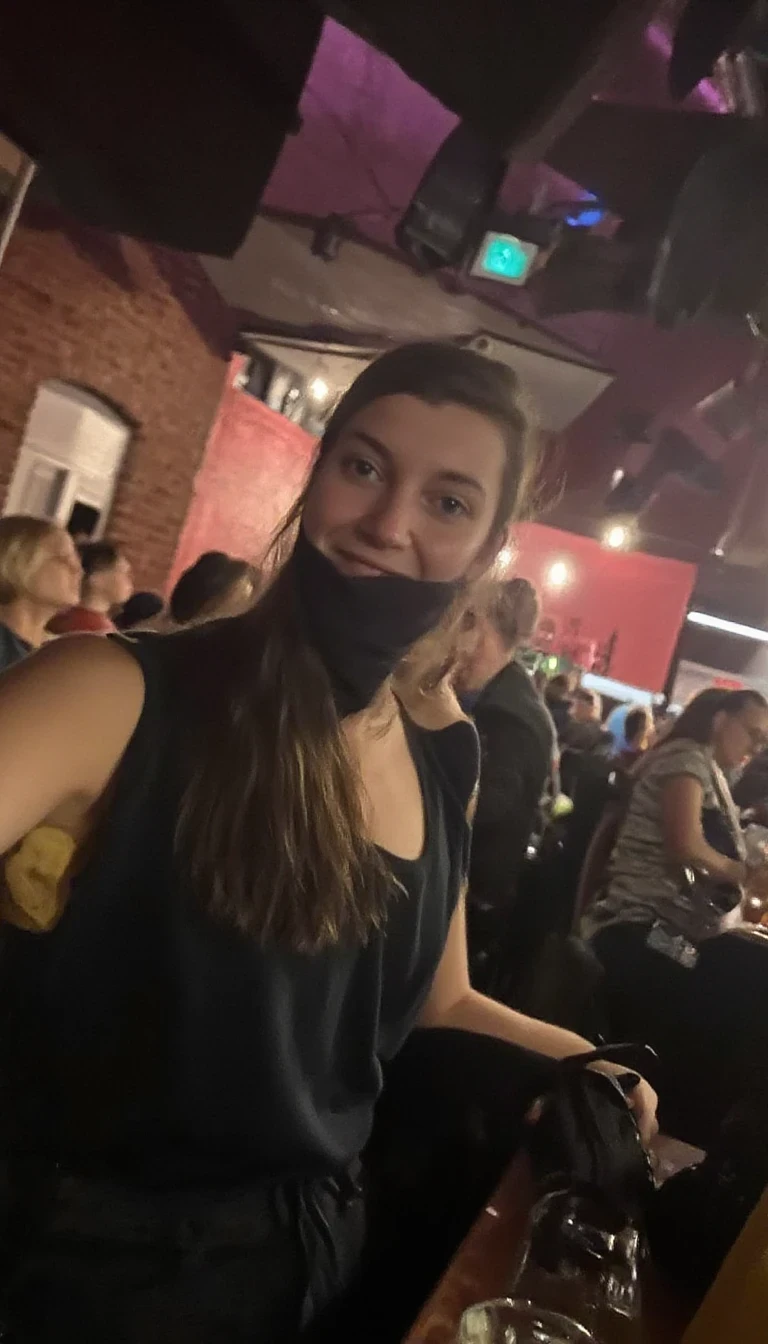 boring low quality snapchat photo circa 2015, woman CSTMDL model at techno party in berghain night club in berlin. at night. the woman CSTMDL model wears a black high neck tanktop. and ripped black jeans.