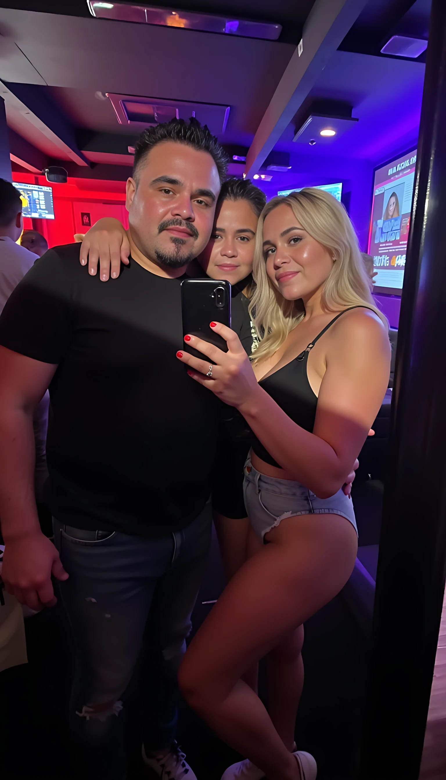 Selfie in a  mirror full man body wearing a  nice black dress shirt   Hugging with blonde girls in a nightclub background 
