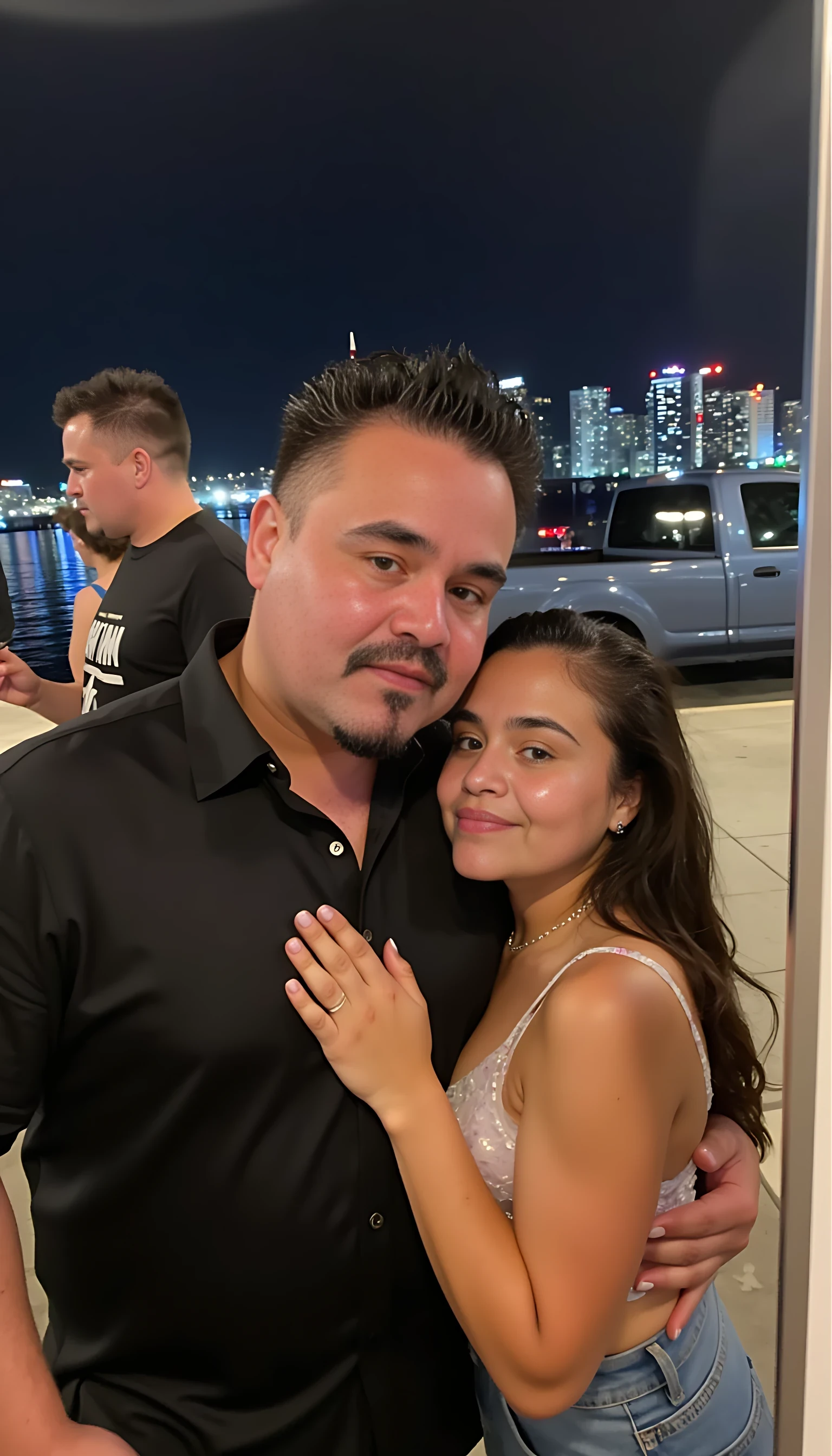 Selfie in a  mirror full man body wearing a  nice black dress shirt   Hugging with 1 blonde girl with blue eyes and 1 Mexican girl in a  big city night lights background 
