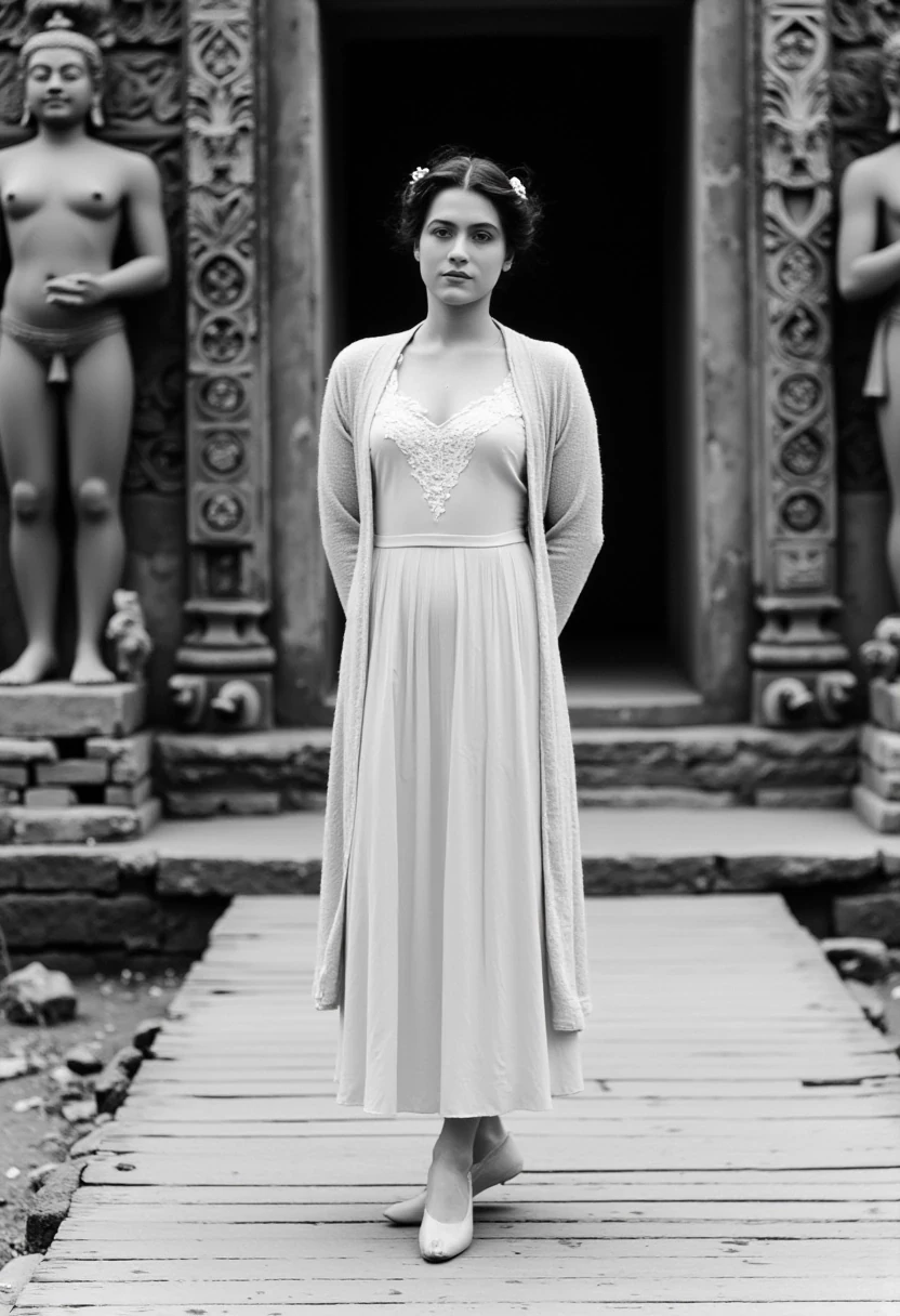 woman CSTMDL, beautiful, hair tied, stands confidently in front of an ancient Cambodian Khmer temple, wearing a vintage 1900 inspired, cream-colored dress with a long coat and lace neckband. She wears a small pendant. The photo is an old black and white type. her hands are gently crossed behind her back. The background features large stone statues and intricate carvings, evoking a sense of historical grandeur. The wooden walkway beneath her adds a touch of rustic charm to the scene.