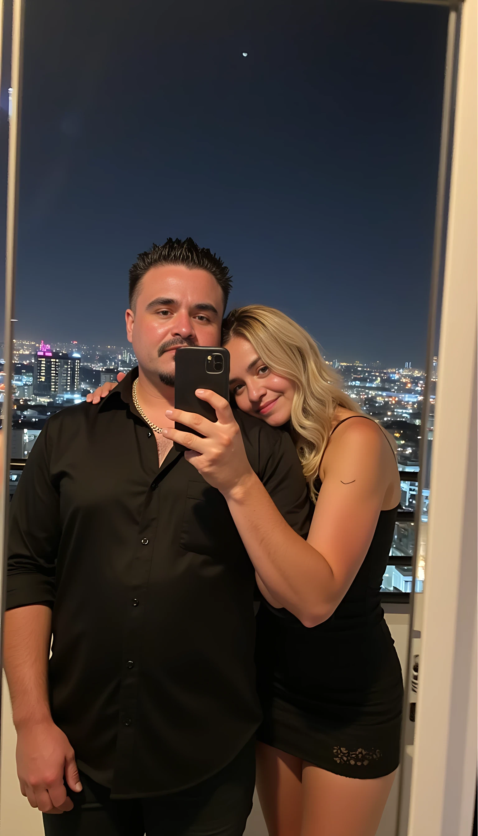 Selfie in a  mirror full man body wearing a  nice black dress shirt   Hugging with 1 blonde girl with blue eyes and 1 Mexican girl in a  big city night lights background 
