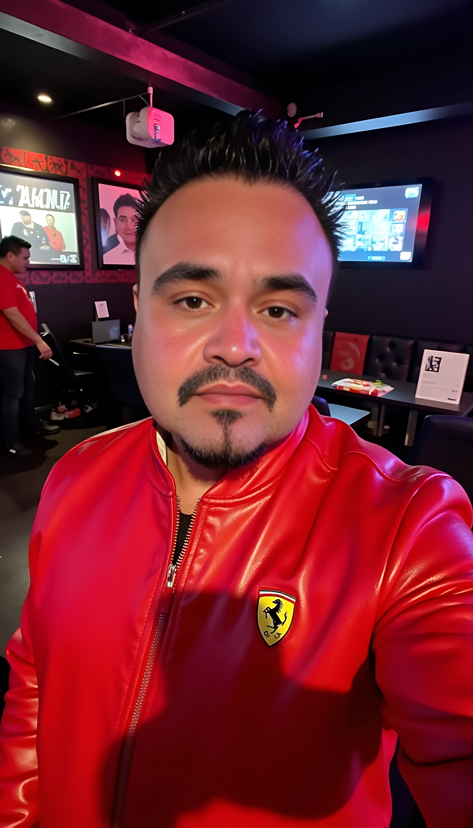 CSTMDL  selfie man average body wearing red leather jacket with a Ferrari logo standing 
With nightclub background 