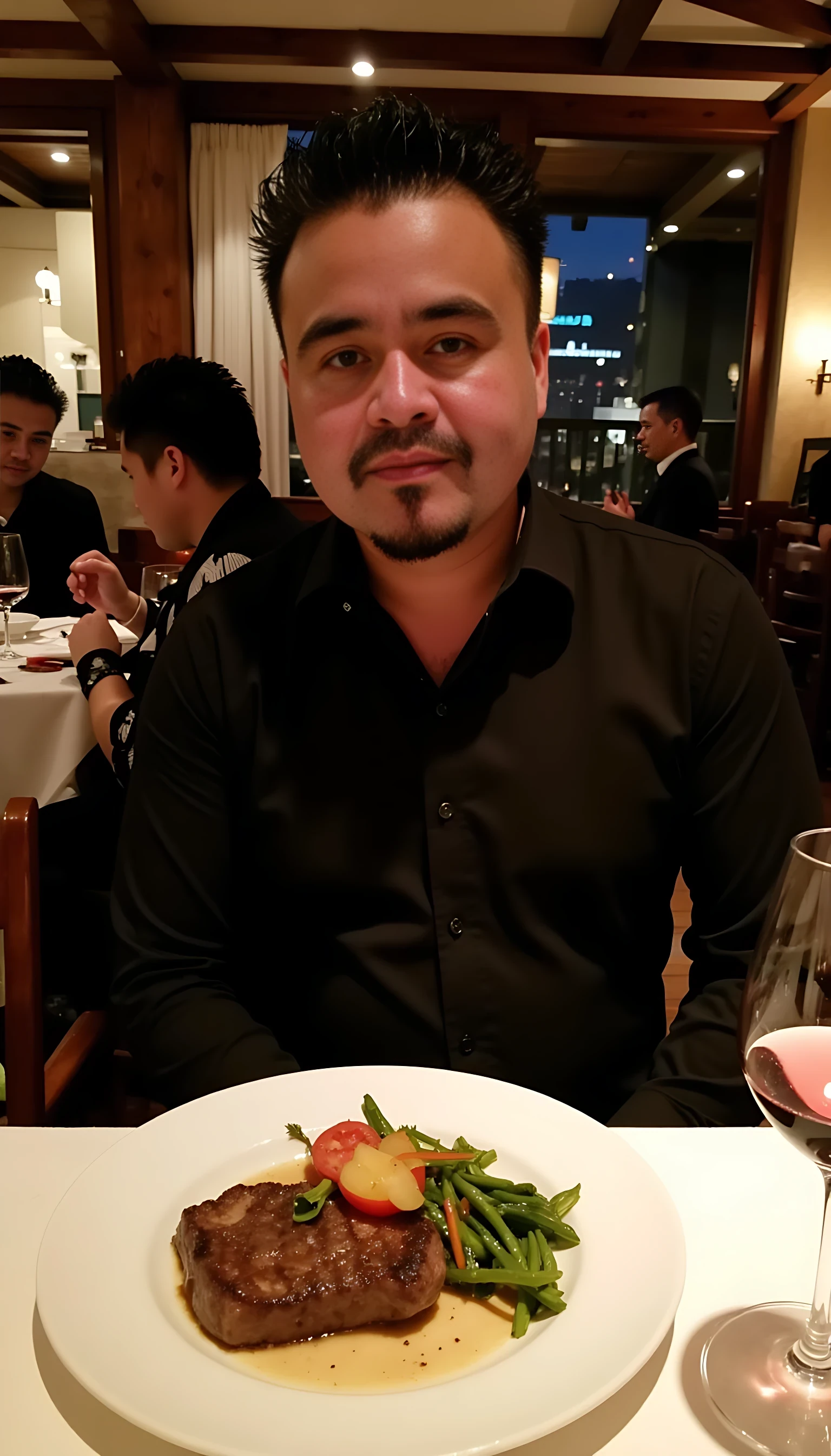 Man average body wearing a  black dress shirt seating on a table of fancy restaurants with low lights  with a plate of steak and vegetables  and a glass of wine 