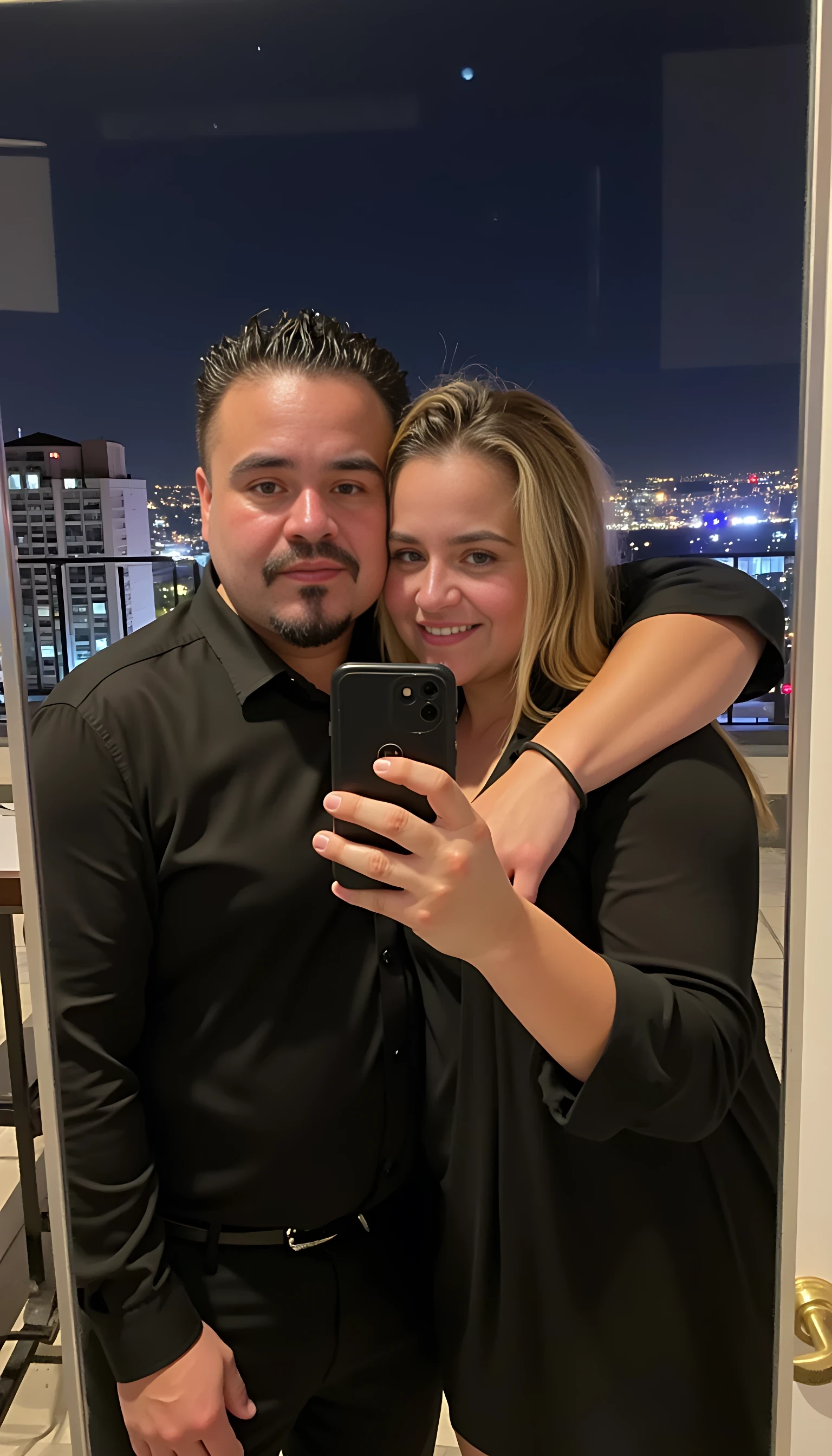 Selfie in a  mirror full man body wearing a  nice black dress shirt   Hugging with 2 blonde girls with blue eyes and 2 Mexican girls in a  big city night lights background 
