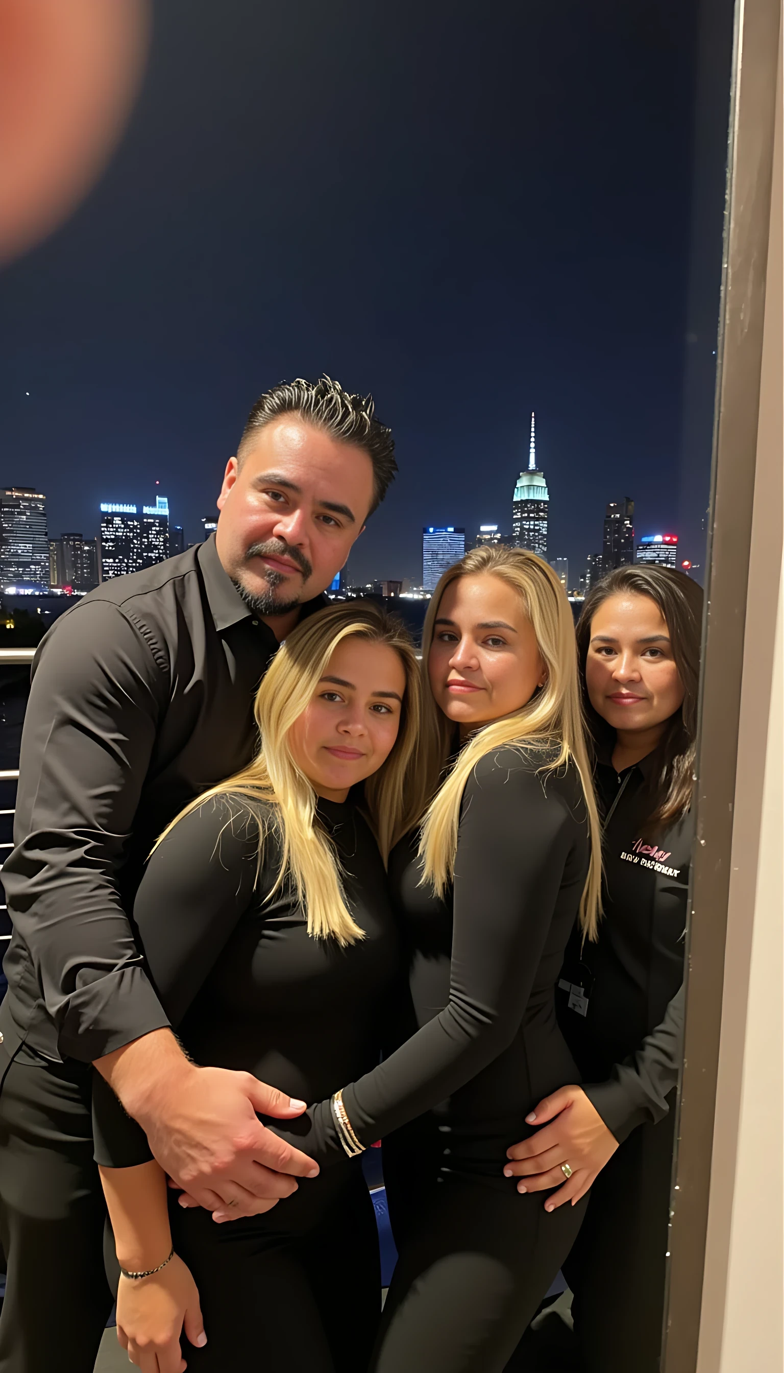Selfie in a  mirror full man body wearing a  nice black dress shirt   Hugging with 2 blonde girls with blue eyes and 2 Mexican girls in a  big city night lights background 
