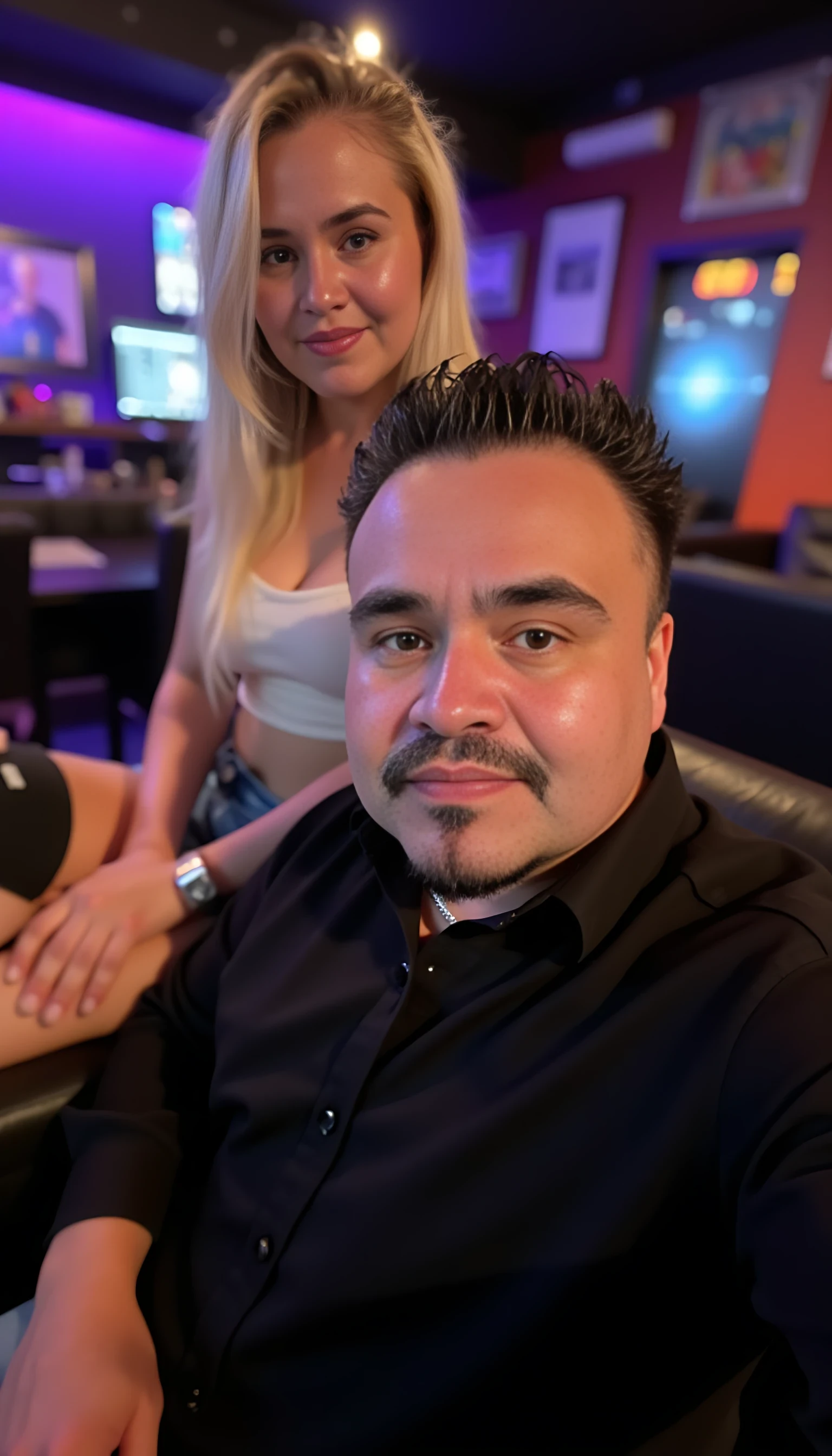 Man full average body with a beautiful blonde woman with blue eyes seating on his lab and a couch  with a night club background 